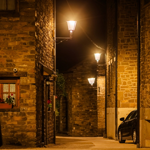 Vista de una calle iluminada de Esposa, donde la luz cálida crea un ambiente acogedor y respetuoso con el cielo nocturno.